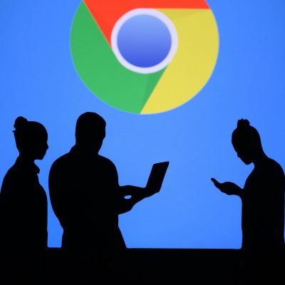 NEW YORK, USA, 25. MAY 2020: Google Chrome web browser developed by Google Group of business people chat on mobile phone and laptop. Company logo on screen in background NEW YORK, USA, 25. MAY 2020: Google Chrome web browser developed by Google Group of business people chat on mobile phone and laptop. Company logo on screen in background